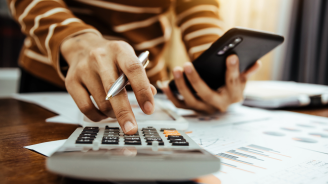 images of a person balancing a budget with a calculator.